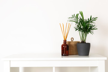 Scandinavian nordic hygge style, home interior - evergreen plant, scent aroma diffuser, small straw...