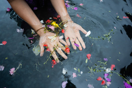 girl's hands on bali holy springs