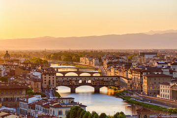 Fototapeta na wymiar City of Florence at sunset with the Arno river
