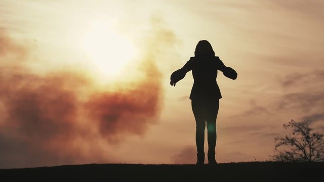 Inspiring lady dancing and jumping with hands aside at sunset in spring in slo-mo   