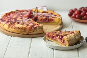 Clafoutis cherry pie on wooden background. Klafuti french cherry pie.