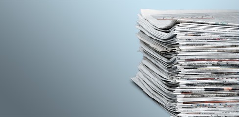 Pile of newspapers on white background