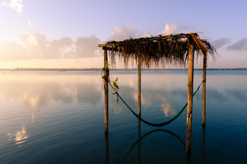 wooden construction with a hammock in a lake called Laguna Milagros at sunset, Chetumal, Mexico © Stefan