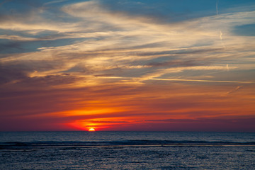 Obraz premium Golden sunset over a beach of the north sea