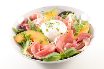 cantaloupe melon with mozzarella and ham on white background