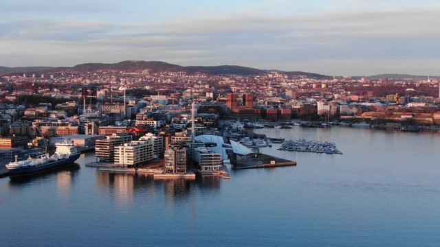 Aerial real time POI shot of Aker Brygge and Filipstad seen towards City Hall in Oslo, Norway at sunset in spring 2019
