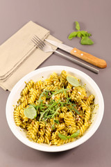 pasta with pesto sauce and arugula