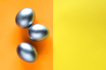 Sandy colored eggs. Yellow, orange background. The symbol of spring. Easter concept. Copy space.