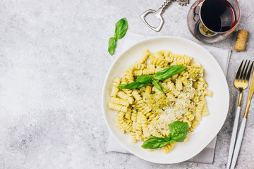 Fusilli pasta with basil, pesto sauce and parmesan cheese