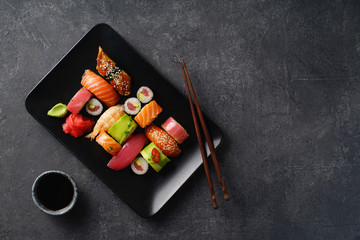 Overhead image of variety of sushi and rolls served on a plate. Shrimp, unagi, crab, salmon and tuna