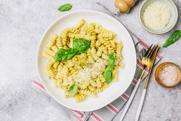 Fusilli pasta with basil, pesto sauce and parmesan cheese