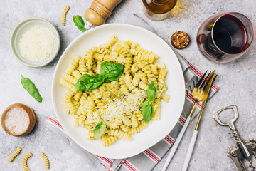 Fusilli pasta with basil, pesto sauce and parmesan cheese
