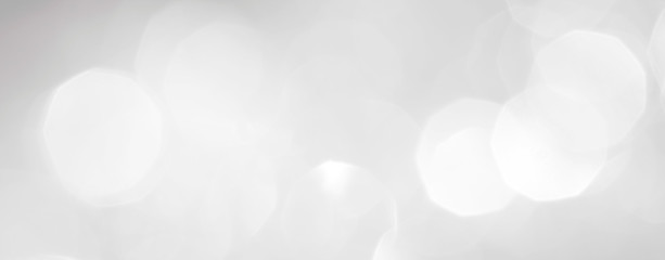 A brilliant white background with circles and ovals. Template for a holiday card with bright and sparkling lights.