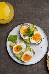 Two sandwiches with avocado and boiled egg on plate