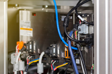 electric wire connected at backside of computer control box for industrial machine