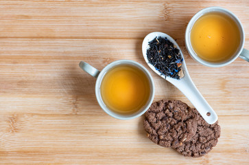 Tea and cookies on the wooden background. 