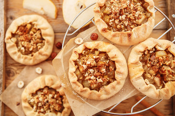 Caramelized pear rustic pie on wooden background