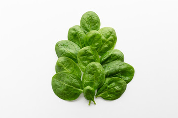 Young green spinach leaves on a white background. Clean food, detox, diet food ingredient - green organic spinach.