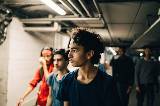 Teenage boys walking in basement