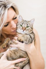 Woman playing with home cat - lovely pet