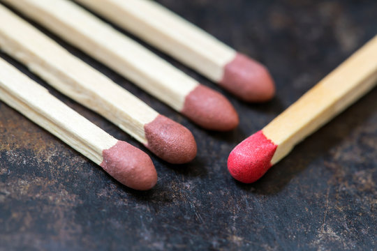 Red brown sulfur matches on a grunge metal background with copy space, close-up