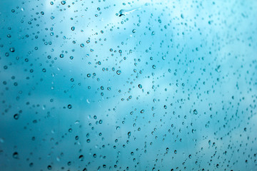 Raindrops on the window show the weather in the rainy season.	