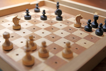 Road chess . Board with chess pieces. The game is on the road. Leisure trip. Game for traveling by train, car, plane.