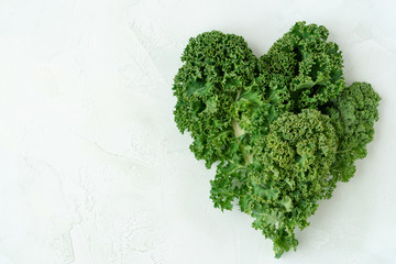  Fresh kale forming a heart .Healthy vegetarian food