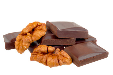 Chocolate bars lie with walnuts on a white background