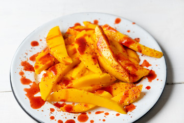 Mexican mangoes with chili powder and chamoy