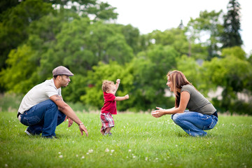 Father and Mother with Toddler Learning to Walk - Color Portrait