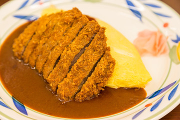 close up Japanese curry omurice with deep fired pork cutlet.