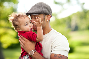 Happy Father Holding Toddler Son Outside - Color Portrait
