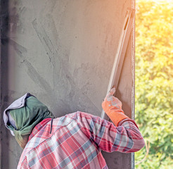 using a trowel to smooth or leveling cement in the wall