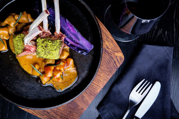 Close up of lamb chops with vegetables with a sauce of caramel, pepper and spices in a restaurant...