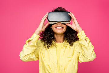 happy african american woman wearing virtual reality headset isolated on crimson
