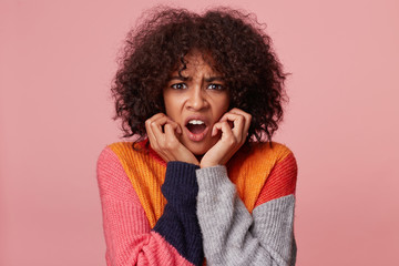 Headshot of hysterical african american girl with afro hairstyle looking in despair and panic,...