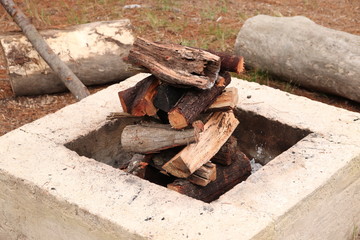 Stacked firewood inside a fire pit. 