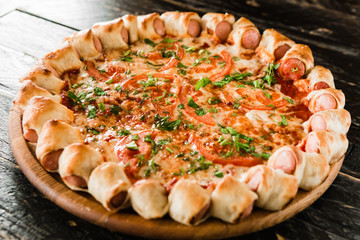 tasty unusual pizza with sausage in a side