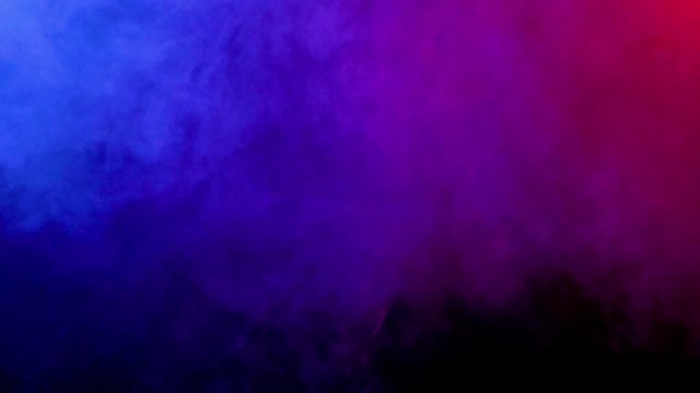 Blue cloud of smoke slowly spreading and floating in the air. Nice background for your text. Blue and red cloud of dense smoke.
