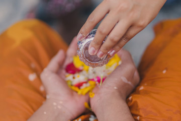 People pouring water to Buddhist Monk and gives blessing in Thailand Songkran annual festival in Buddhist temple.