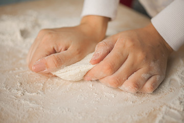 Making dough by female hands at home