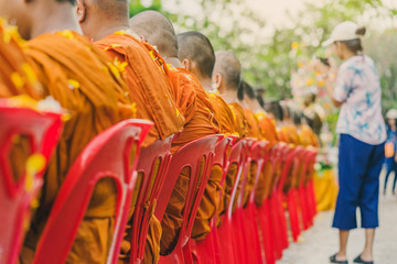 People pouring water to Buddhist Monk and gives blessing in Thailand Songkran annual festival in Buddhist temple.