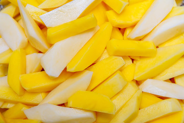 Potatoes cut into strips and lay in a fryer rack on the table