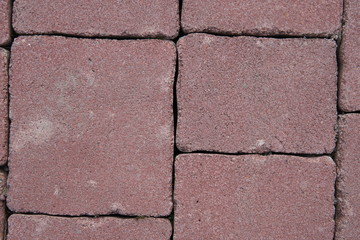 Stone pavement in perspective. Stone pavement texture. Granite cobblestoned pavement background. Abstract background of a cobblestone pavement close-up