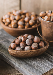 Hazelnuts on rustic wooden background. Food background. Print for kitchen