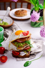 Bagels with ham, fried eggs and guacamole