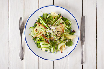 Spring vegetable salad on a wooden surface