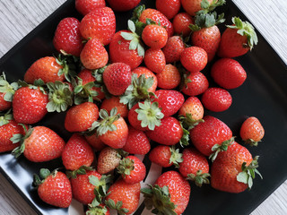 Strawberries on a black plate