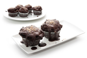 Brown chocolates on plates on a white background